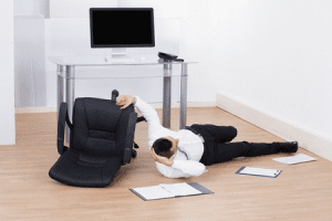 Man falling off a chair at work