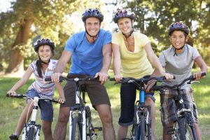 Family members all riding bicycles together