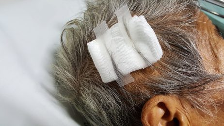 Man with a head injury with a gauze on his head