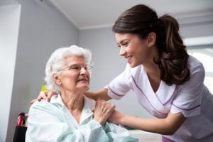 Care worker holding onto an older lady client