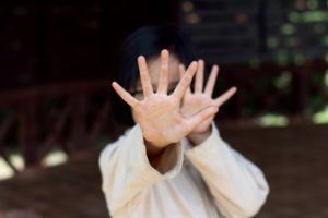 Child protecting their face from someone