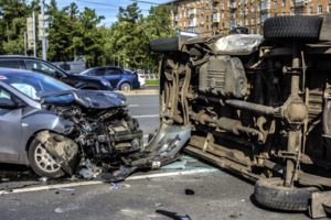 Two destroyed cars in the middle of a road