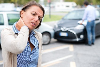 Woman holding injured neck after a split liability car accident