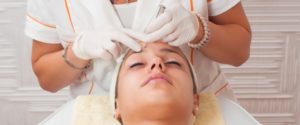 Woman getting a facial treatment in a beauty salon