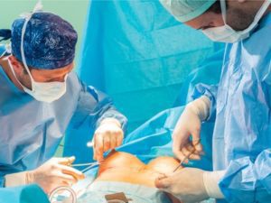 Breast Augmentation Surgery Being Performed By Two Surgeons. 