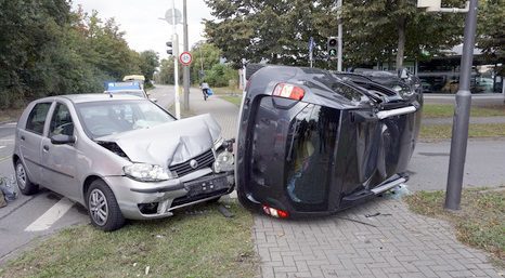 two cars crashing together after trying to merge lanes