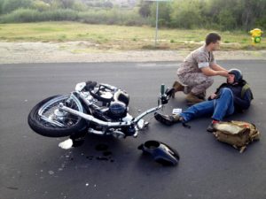 Man helping a biker who has just crashed