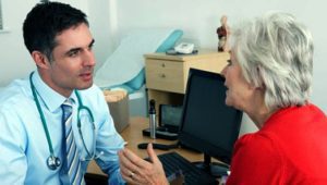 A medical professional and a woman discussing psychological injury compensation
