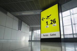 Sign directing customers to airport gates at an airport in France