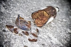 A broken glass bottle on the floor