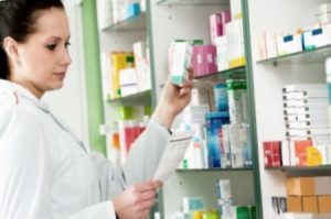 Pharmacist looking over different prescription medication