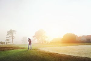 A person walking through a golf course