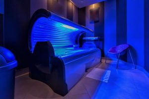 An empty sunbed inside a tanning salon