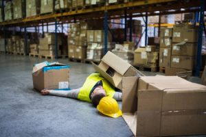 Man slipping and falling while carrying boxes at work