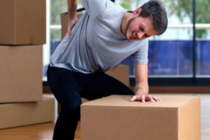 A man with back pain who would like to know what manual handling weight limits apply to workplaces.