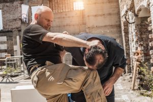 A male worker being assaulted by another man