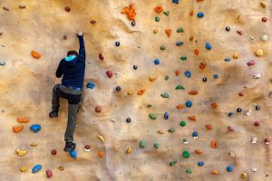A person attempting a climbing wall activity