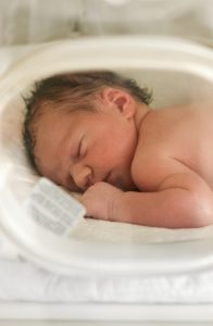 Baby laying down in an incubator