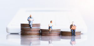 Representation of serious injury compensation payouts with 3 figurines sitting on different amounts of pennies