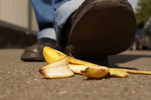 Man walking about to step on banana peel on the ground