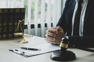 A Solicitor With Folded Hands At A Table. 