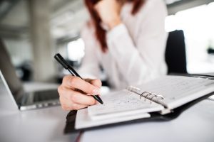 A manager fills in the accident book as part of the accident at work procedure. 