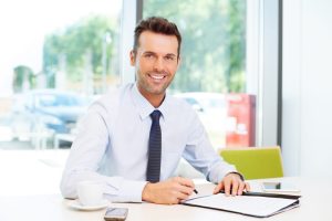 A solicitor in a white shirt sitting at a desk. A solicitor could help you claim compensation if an organisation misused your data.