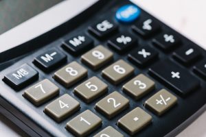 A close-up shot of the numbers on a calculator to represent data breach compensation.