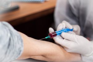 A doctor injects a patient.