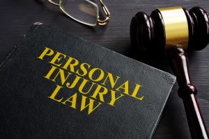 A black book with the words personal injury law written on the front, used to give personal injury lawyers proper training