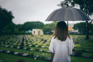PERSON STANDING IN GRAVEYARD