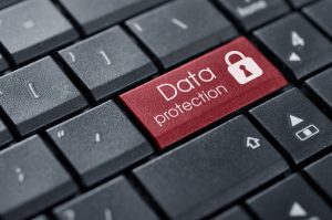 CLOSE UP OF WORKPLACE KEYBOARD READING 'DATA PROTECTION''