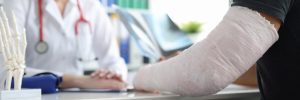 A doctor discusses future complications with a patient who has a broken arm. 