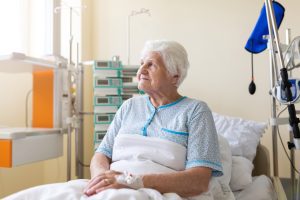 Old woman in hospital bed.
