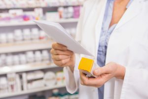 A pharmacist checks a prescription