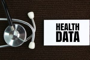 An image shows a card which says 'health data' next to a stethoscope.
