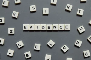 Blocks spelling out the word 'evidence' on a grey background.