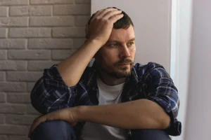 Upset man with hand to head.