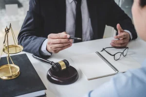 A solicitor at desk provides legal advice for leg injury claims.